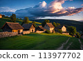 Panoramic top view of an old small abandoned ruined village on the hills with thatched roof huts at sunset with clouds in the sky 113977702