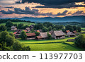 Panoramic top view of an old small abandoned ruined village on the hills with thatched roof huts at sunset with clouds in the sky 113977703