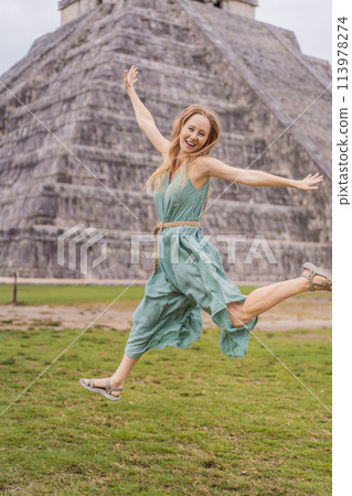Beautiful tourist woman observing the old pyramid and temple of the castle of the Mayan architecture known as Chichen Itza these are the ruins of this ancient pre-columbian civilization and part of Beautiful tourist woman observing the old pyramid and temple of the castle of the Mayan architecture known as Chichen Itza these are the ruins of this ancient pre-columbian civilization and part of 113978274
