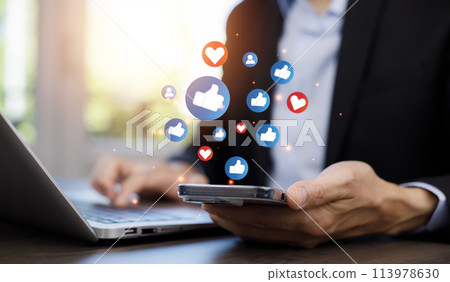 Hand holding smartphone and Social media and digital online concept, smart phone with Social media, concept of living on vacation and playing social media. Social Distancing 113978630