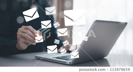 Businessmen use laptops with communication icons, letter icons, email icons, and newsletter email and protect your personal information or spam mail, Customer service call center contact. Businessmen use laptops with communication icons, letter icons, email icons, and newsletter email and protect your personal information or spam mail, Customer service call center contact. 113978659