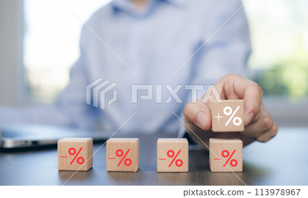 Man chosen cube with check percent symbol printed on its one side, viewed in close-up, Interest rate financial and mortgage rates, Increasing interest rates or discount sale concept,sale and discount 113978967