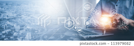 Businessman holding glowing light bulb with AI Data Management System on the computer, Hands working on a laptop cloud network graphic overlay, connected to the database. Corporate strategy finance 113979082