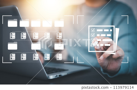 Businesswoman working on laptop with virtual screen. Online documentation database, IT consultant being set up Virtual Document Management System with a laptop, Software for archiving corporate files. 113979114