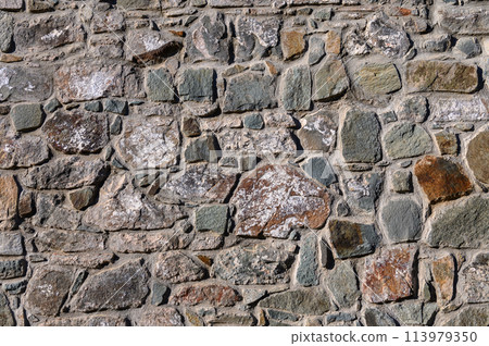 Old wall made of rocks and mortar. Can be used as background 113979350