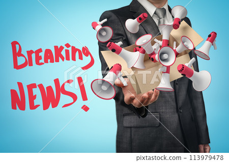Businessman levitating box full of red and white megaphones that are flying out of it 113979478