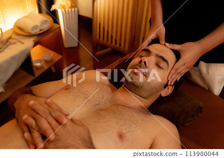 Caucasian man enjoying relaxing anti-stress head massage. Quiescent 113980044