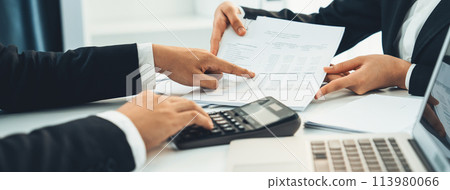 Corporate accountant team use calculator to calculate financial report. Shrewd Corporate accountant team use calculator to calculate financial report. Shrewd 113980066