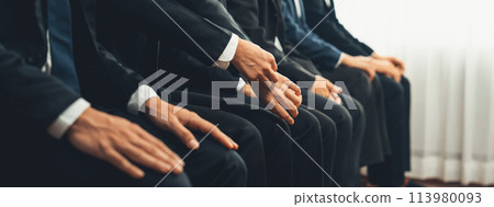 Job candidates in formal suits line up for interview at HR agency. 113980093