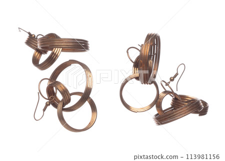 Fashion gold Earrings with beautiful work detail is value. Luxury golden earring is fashion trend and fly in air. White background isolated 113981156