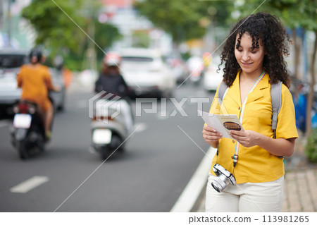 Woman reading information in brochure 113981265