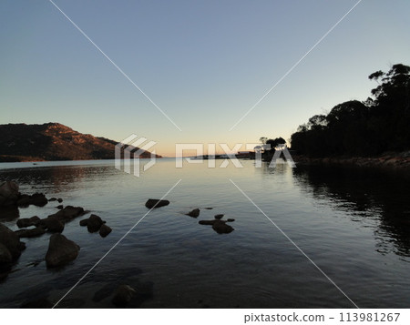 Sunset seen from across the sea 113981267