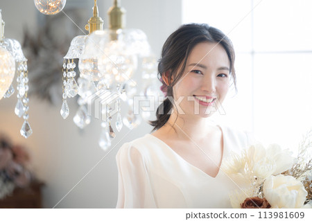 Young Japanese (Asian) woman wearing a wedding dress. Image of a bride's wedding, such as pre-wedding photo shoot or bridal Young Japanese (Asian) woman wearing a wedding dress. Image of a bride's wedding, such as pre-wedding photo shoot or bridal 113981609