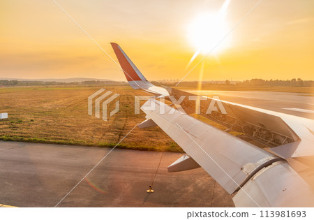 View on sunset and airplane wing from the inside View on sunset and airplane wing from the inside 113981693