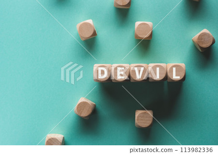 There is a wooden cube with the word DEVIL on it, which is an eye-catching image. There is a wooden cube with the word DEVIL on it, which is an eye-catching image. 113982336