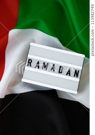 Congratulations Lightbox with text RAMADAN waving UAE flag on background concept. Greeting card advertisement. Commemoration Day Muslim Blessed holy month holiday Congratulations Lightbox with text RAMADAN waving UAE flag on background concept. Greeting card advertisement. Commemoration Day Muslim Blessed holy month holiday 113982749