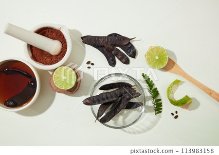 Ingredients for producing black locust pods products neatly arranged on white texture. Advertising photo with blank space for displaying product Ingredients for producing black locust pods products neatly arranged on white texture. Advertising photo with blank space for displaying product 113983158