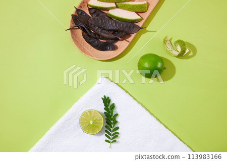 Template of natural ingredients for cosmetic with black locust pod, lime, grapefruit peel and fern flat lay on green table. Locust tree is a medicinal herb that brings many benefits to health and life Template of natural ingredients for cosmetic with black locust pod, lime, grapefruit peel and fern flat lay on green table. Locust tree is a medicinal herb that brings many benefits to health and life 113983166