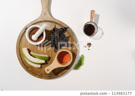 Several type of composition for produce manufacturing extract from black locust displayed on a wooden chopping board on white background. Copy space with top view Several type of composition for produce manufacturing extract from black locust displayed on a wooden chopping board on white background. Copy space with top view 113983177