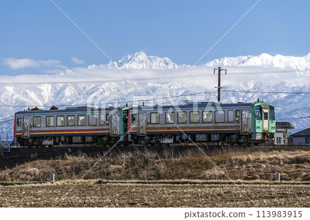 Tateyama mountain range and Takayama Main Line train Tateyama mountain range and Takayama Main Line train 113983915
