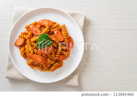 spirali or spiral pasta with tomato sauce 113985460