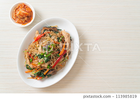 japchae or stir-fried Korean vermicelli noodles with vegetables and pork topped with white sesame 113985819