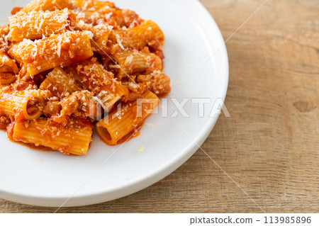 Rigatoni pasta bolognese with cheese 113985896