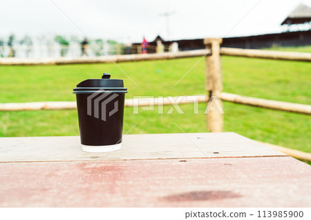 coffee cup on wood table with Mountain hill View background 113985900