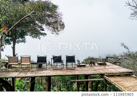 chair on balcony with mountain hill and foggy background 113985905