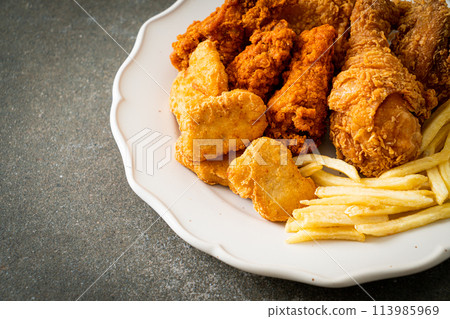 fried chicken with french fries and nuggets on plate 113985969