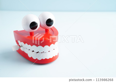 Funny red teeth with eye toy denture model for dental health care. 113986268