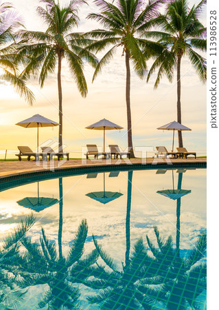Umbrella and chair around swimming pool in resort hotel for leisure travel and vacation neary sea ocean beach Umbrella and chair around swimming pool in resort hotel for leisure travel and vacation neary sea ocean beach 113986528