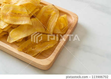Banana Chips - fried or baked sliced banana 113986702