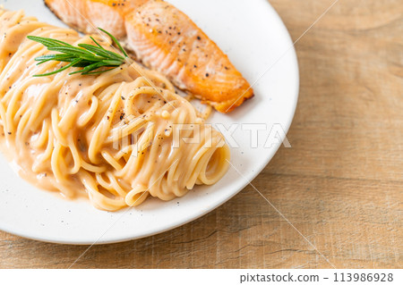 grilled salmon with spaghetti creamy tomato sauce 113986928
