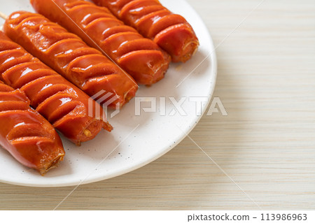 fried sausage skewer on plate 113986963