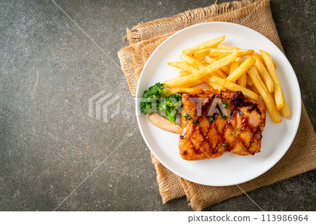grilled chicken steak with potato chips or french fries grilled chicken steak with potato chips or french fries 113986964