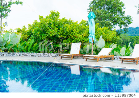 pool bed around swimming pool with mountain hill background pool bed around swimming pool with mountain hill background 113987004