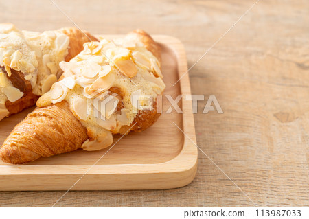 croissant with cream and almonds croissant with cream and almonds 113987033