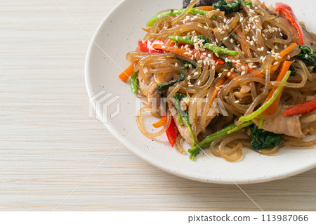japchae or stir-fried Korean vermicelli noodles with vegetables and pork topped with white sesame japchae or stir-fried Korean vermicelli noodles with vegetables and pork topped with white sesame 113987066