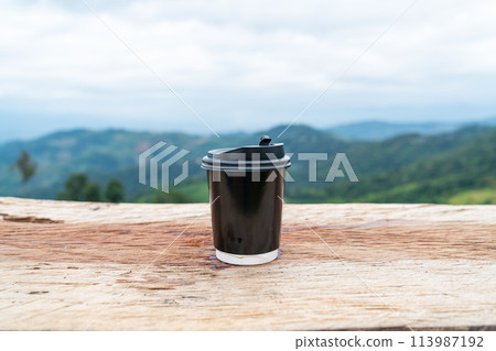 coffee cup on wood table with Mountain hill View background coffee cup on wood table with Mountain hill View background 113987192