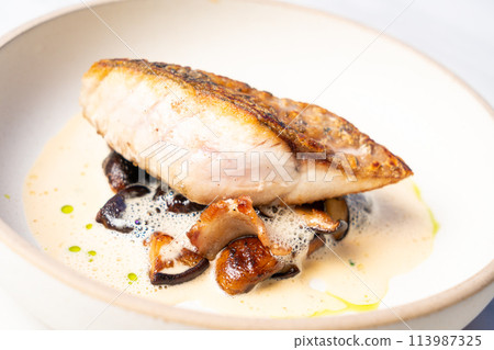 grilled Barramundi steak with mushroom sauce 113987325