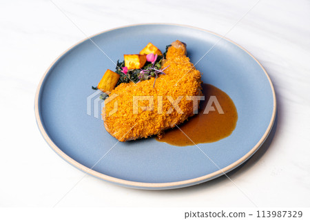fried chicken thigh with vegetable and sauce fried chicken thigh with vegetable and sauce 113987329