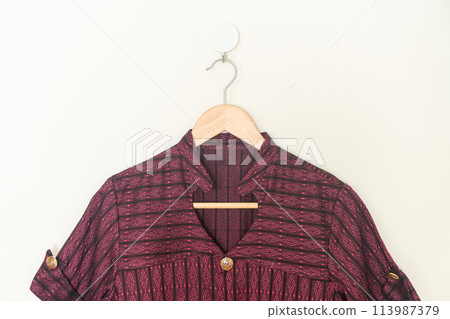 beautiful woman shirt hanging on wall beautiful woman shirt hanging on wall 113987379