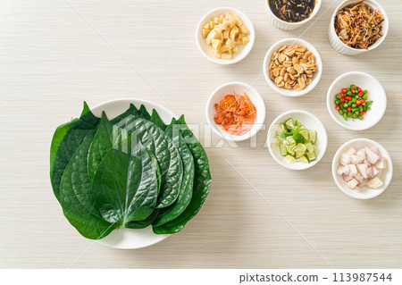 Miang kham - A royal leaf wrap appetizer Miang kham - A royal leaf wrap appetizer 113987544