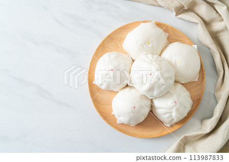 stuffed steamed bun on wood plate stuffed steamed bun on wood plate 113987833