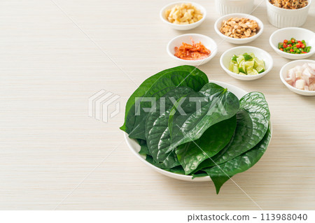 Miang kham - A royal leaf wrap appetizer Miang kham - A royal leaf wrap appetizer 113988040