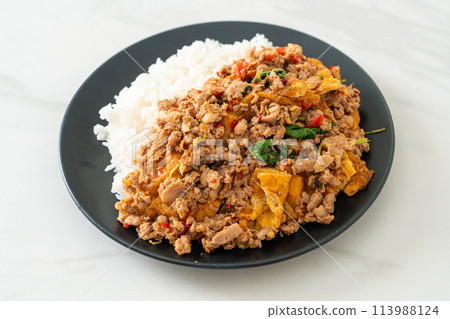 stir-fried minced pork with basil and egg topped on rice stir-fried minced pork with basil and egg topped on rice 113988124