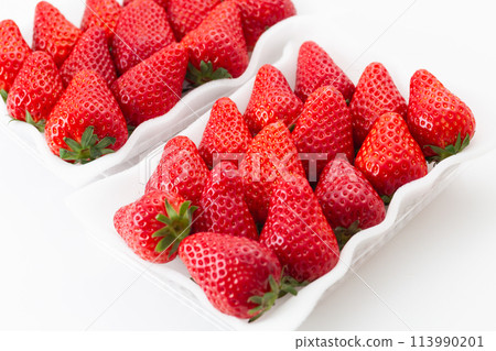 Large strawberries in a pack on a white background Large strawberries in a pack on a white background 113990201