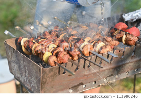 cooking a barbecue on the grill. put out the fire in the grill. cooking a barbecue on the grill. put out the fire in the grill. 113990246