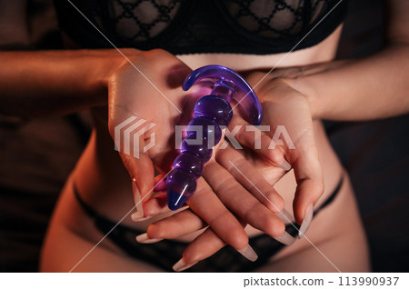 bester vibrator frau sexy girl holds a silicone butt anal plug in... - Stock Photo [113990937]